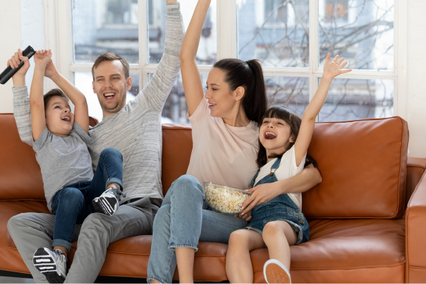 family cheering on the sofa