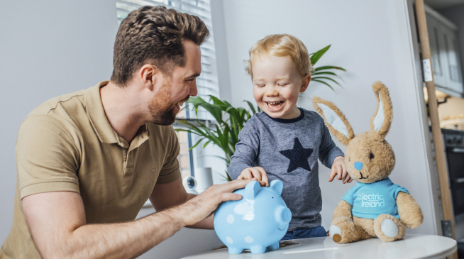Father and Son with Money Box